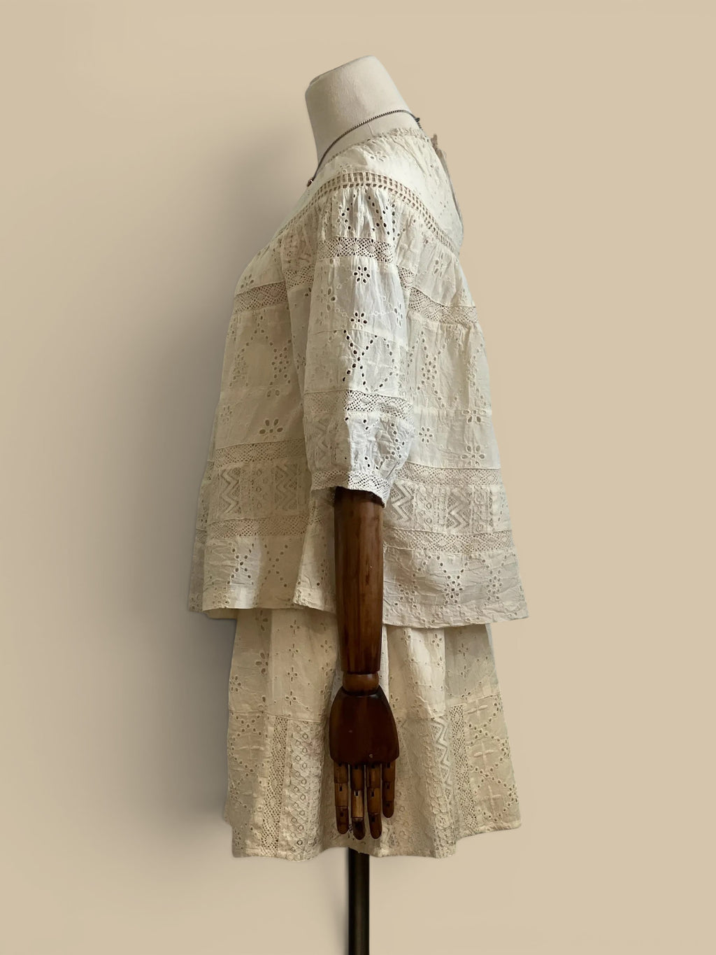Homestyle Collective Dureya white cotton eyelet top with lace trim and elbow-length sleeves on a mannequin