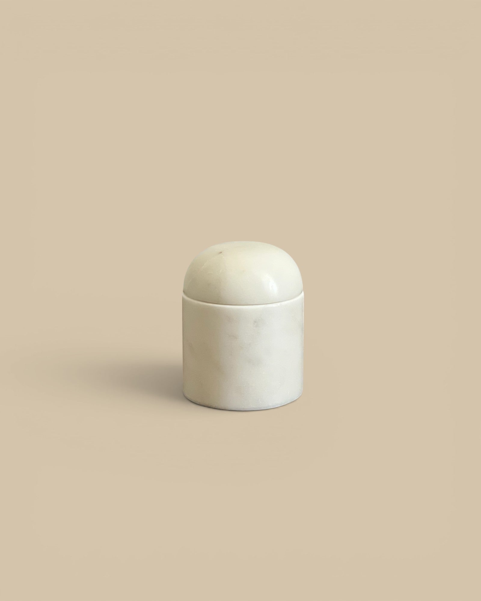 Homestyle Collective white marble dome canister with subtle veining, perfect for storage or decor.