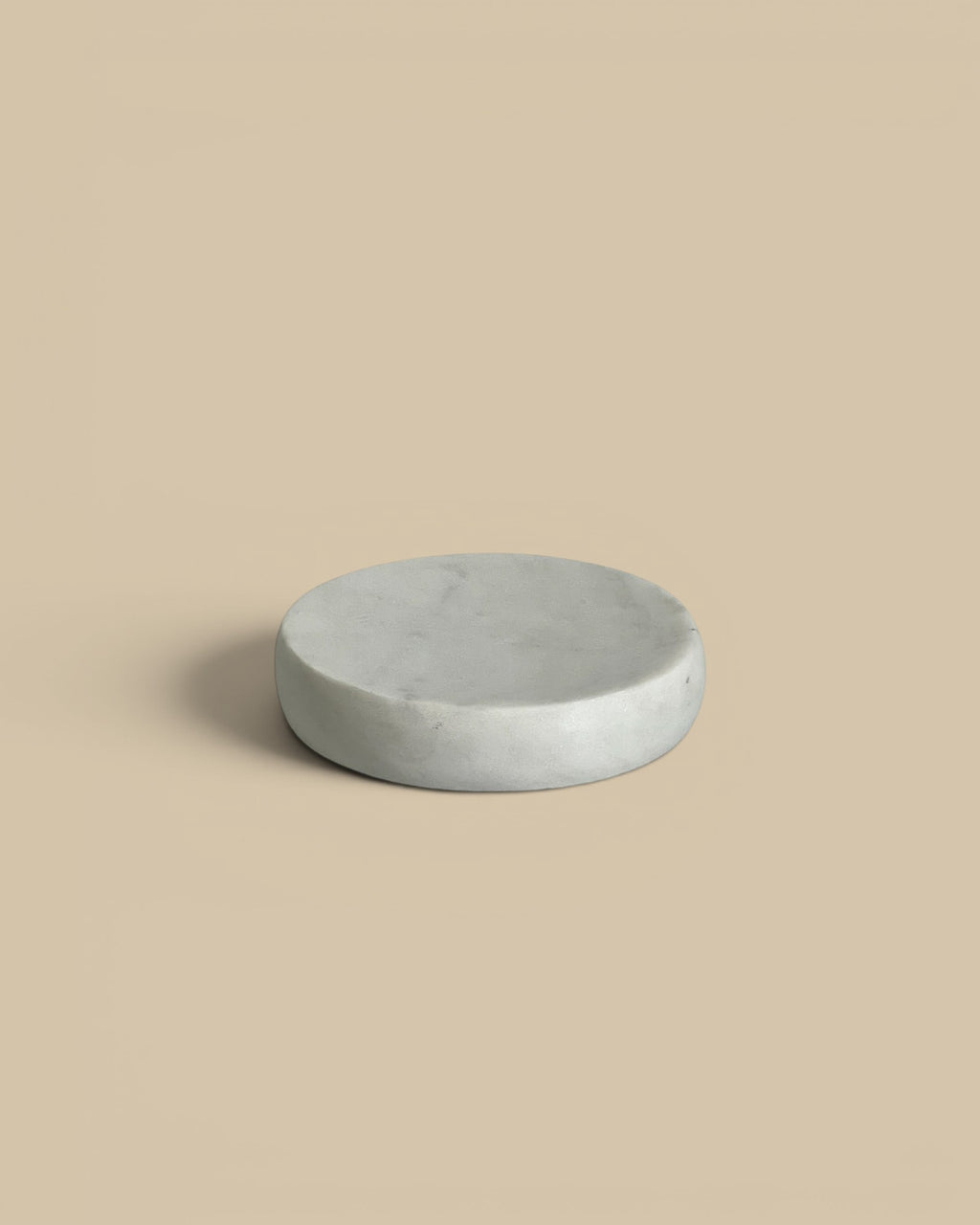 Homestyle Collective white marble round soap dish with a smooth, sculptural form. Modern bathroom accent.