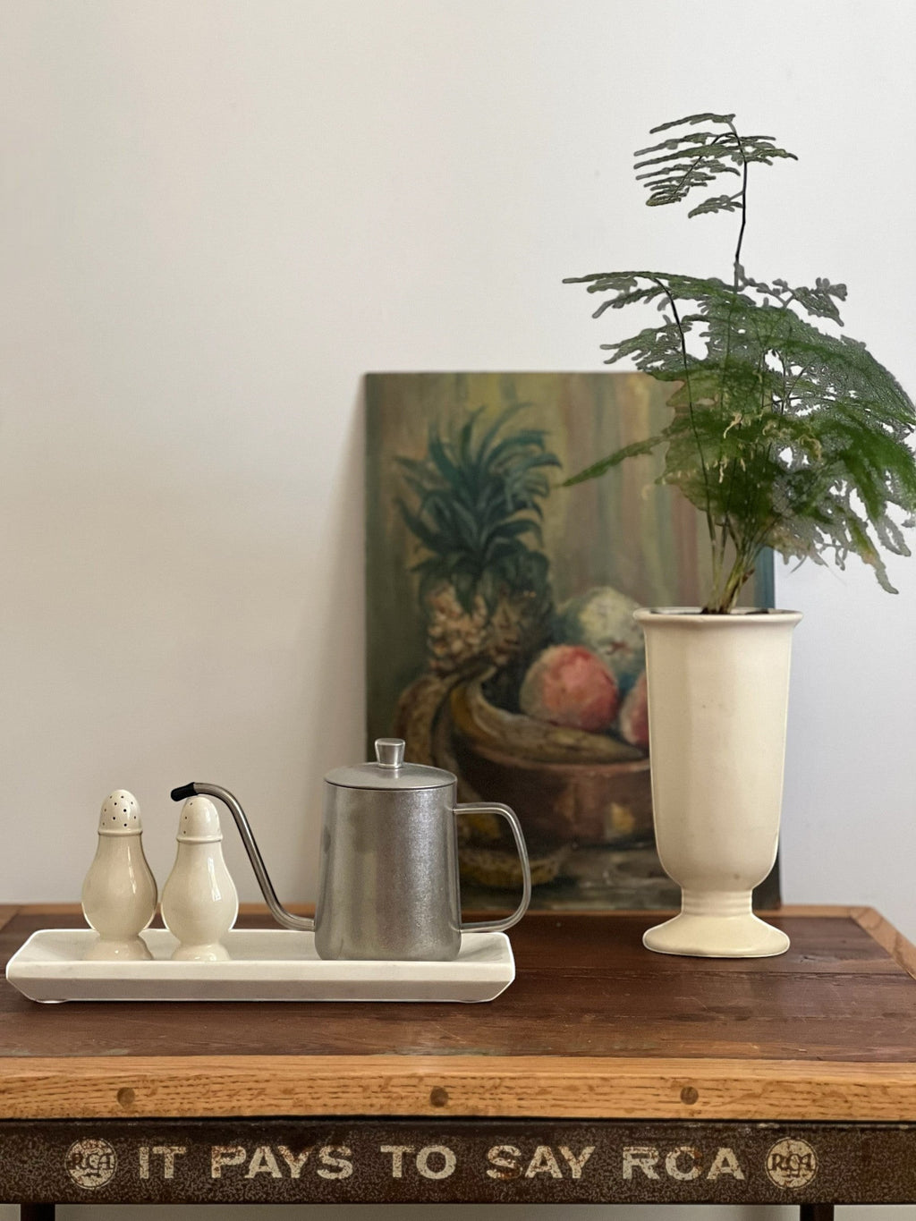 Homestyle Collective white marble decorative tray with a subtly mottled finish and raised edge, holding salt and pepper shakers and a small metal pitcher.