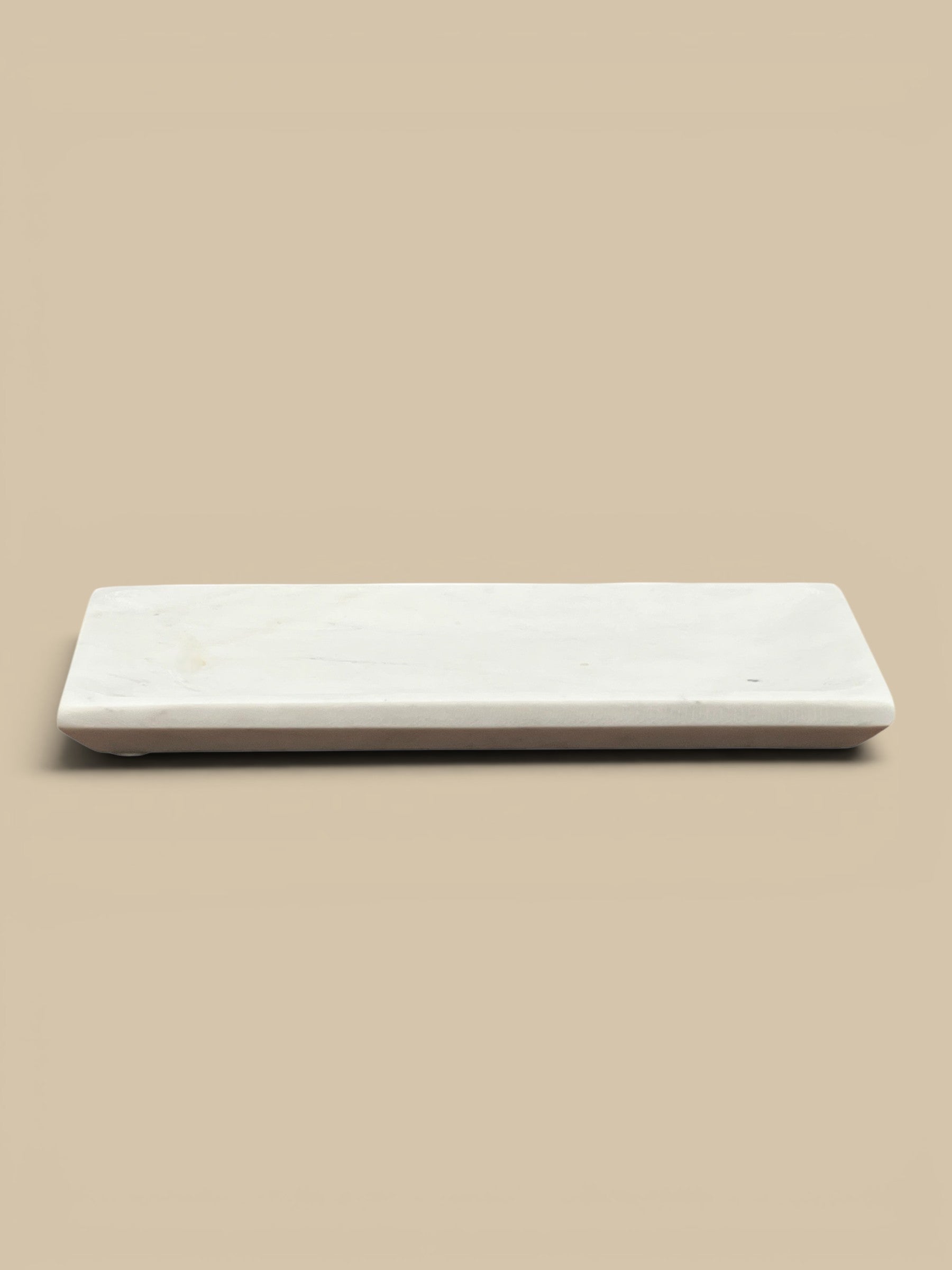 Homestyle Collective white marble rectangular decorative tray with a subtly mottled finish and raised edge.