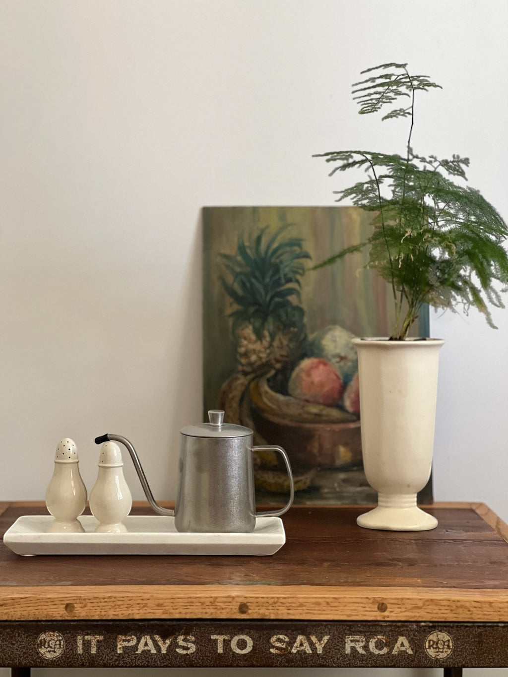 Homestyle Collective white marble decorative tray with a subtly mottled finish and raised edge, holding salt and pepper shakers and a small metal pitcher.