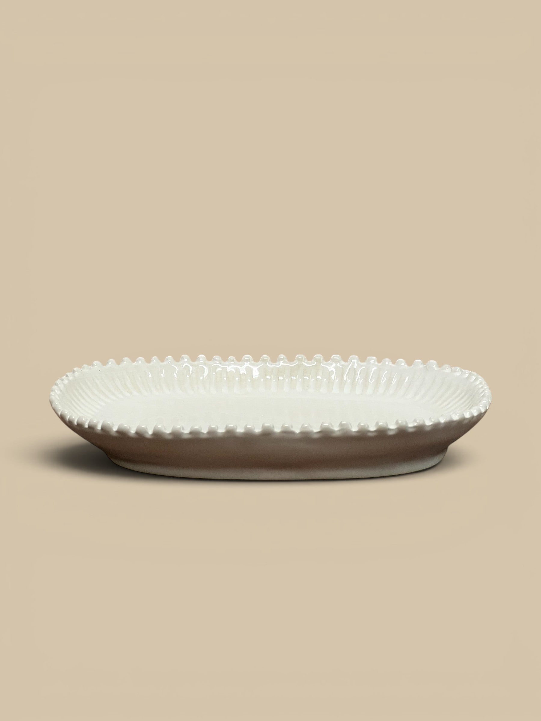 Homestyle Collective white ceramic oval serving tray with beaded edge detail and ribbed interior.