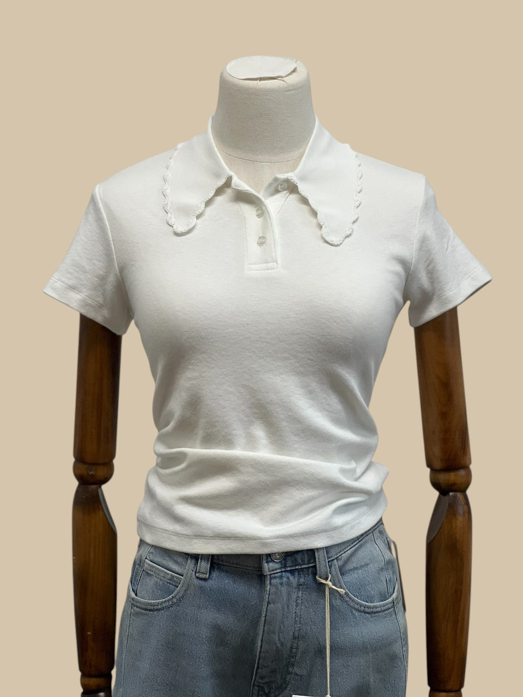 Homestyle Collective white knit polo shirt with short sleeves and a scalloped edge collar. Features a classic button placket.