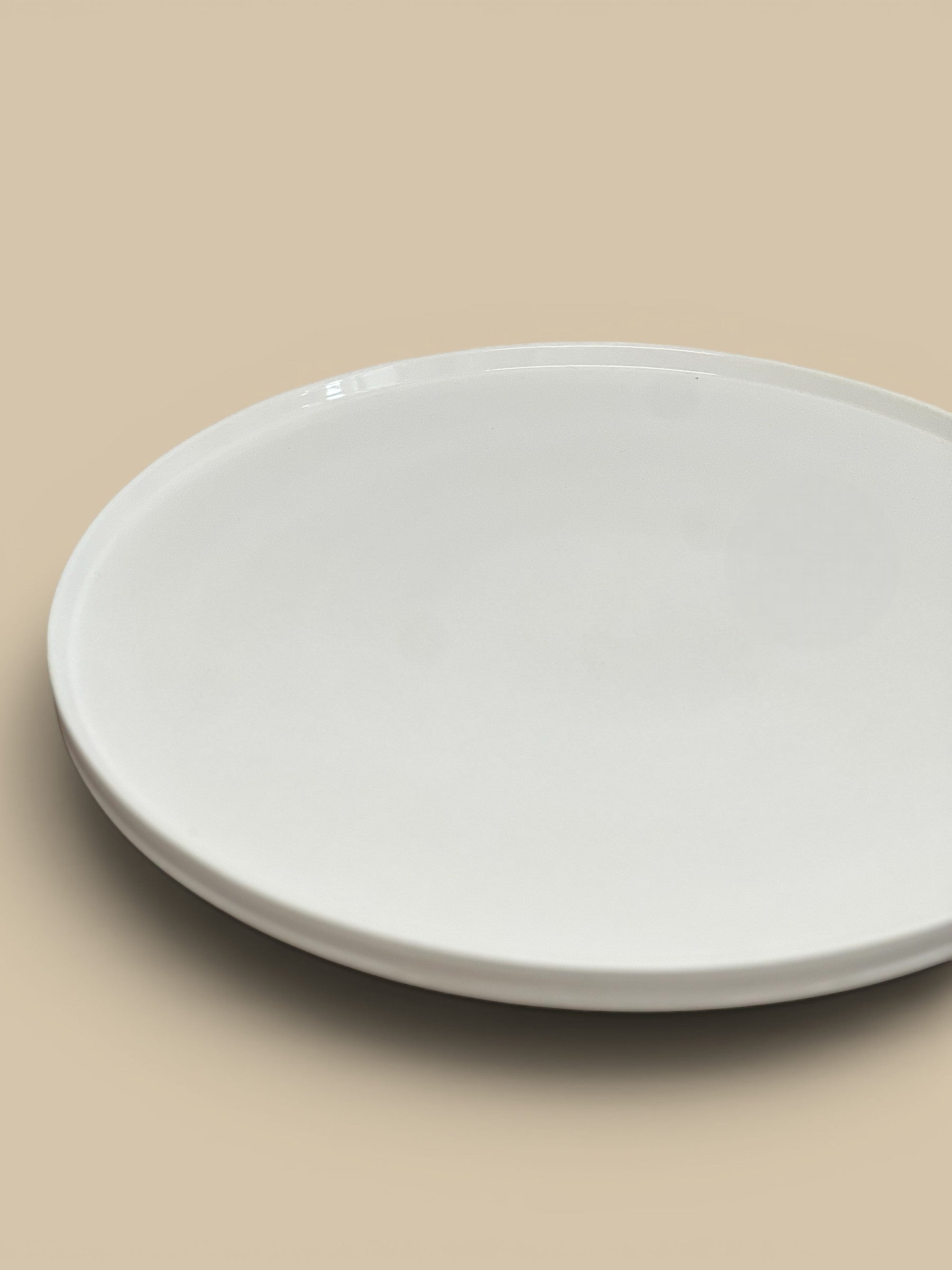 Homestyle Collective white stoneware pedestal with a smooth glossy finish and a classic round lipped silhouette, 18" round.