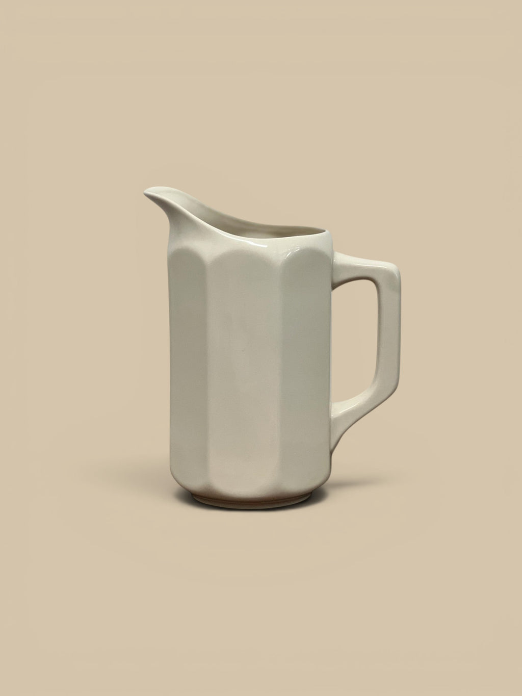Homestyle Collective white flour stoneware pitcher with faceted sides and a modernist design. Ideal for serving drinks or holding flowers.