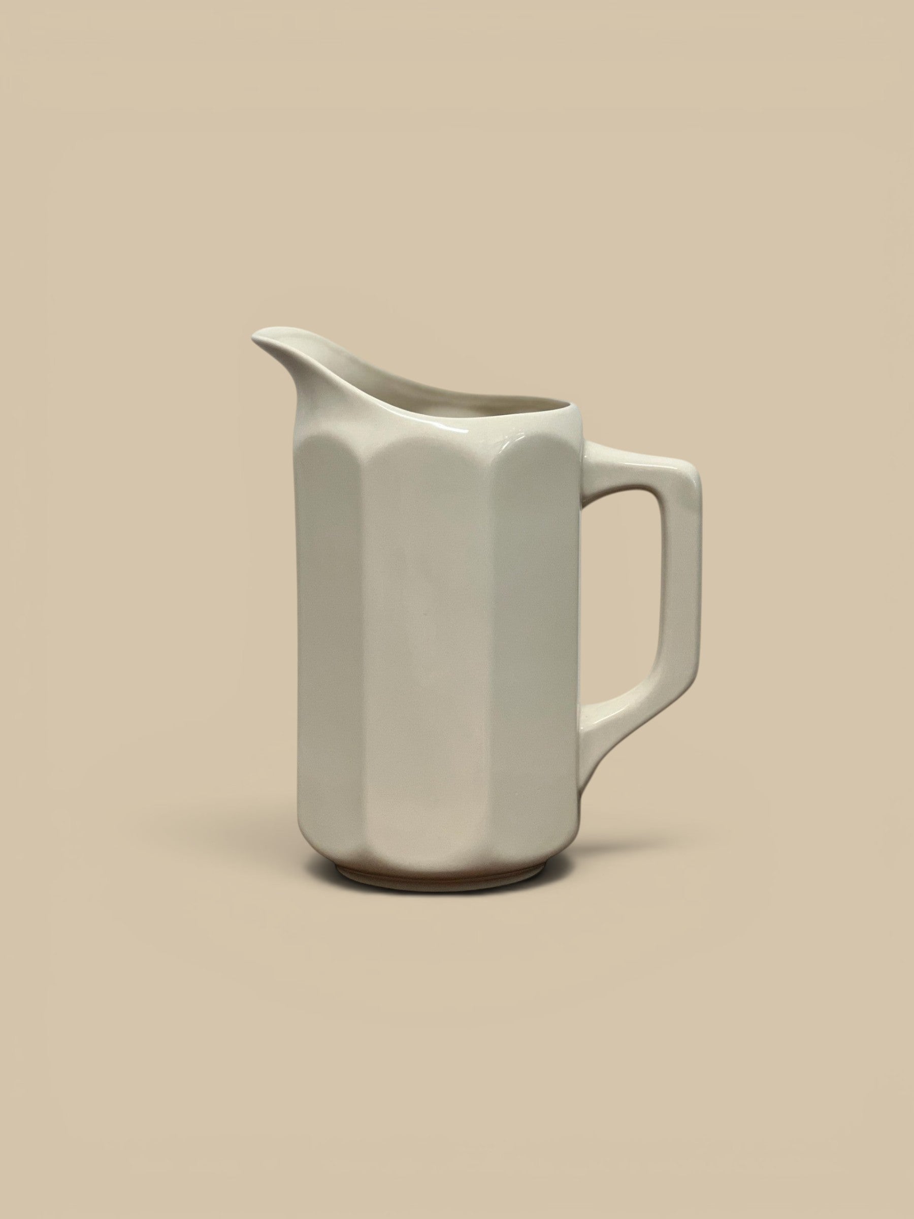 Homestyle Collective white flour stoneware pitcher with faceted sides and a modernist design. Ideal for serving drinks or holding flowers.
