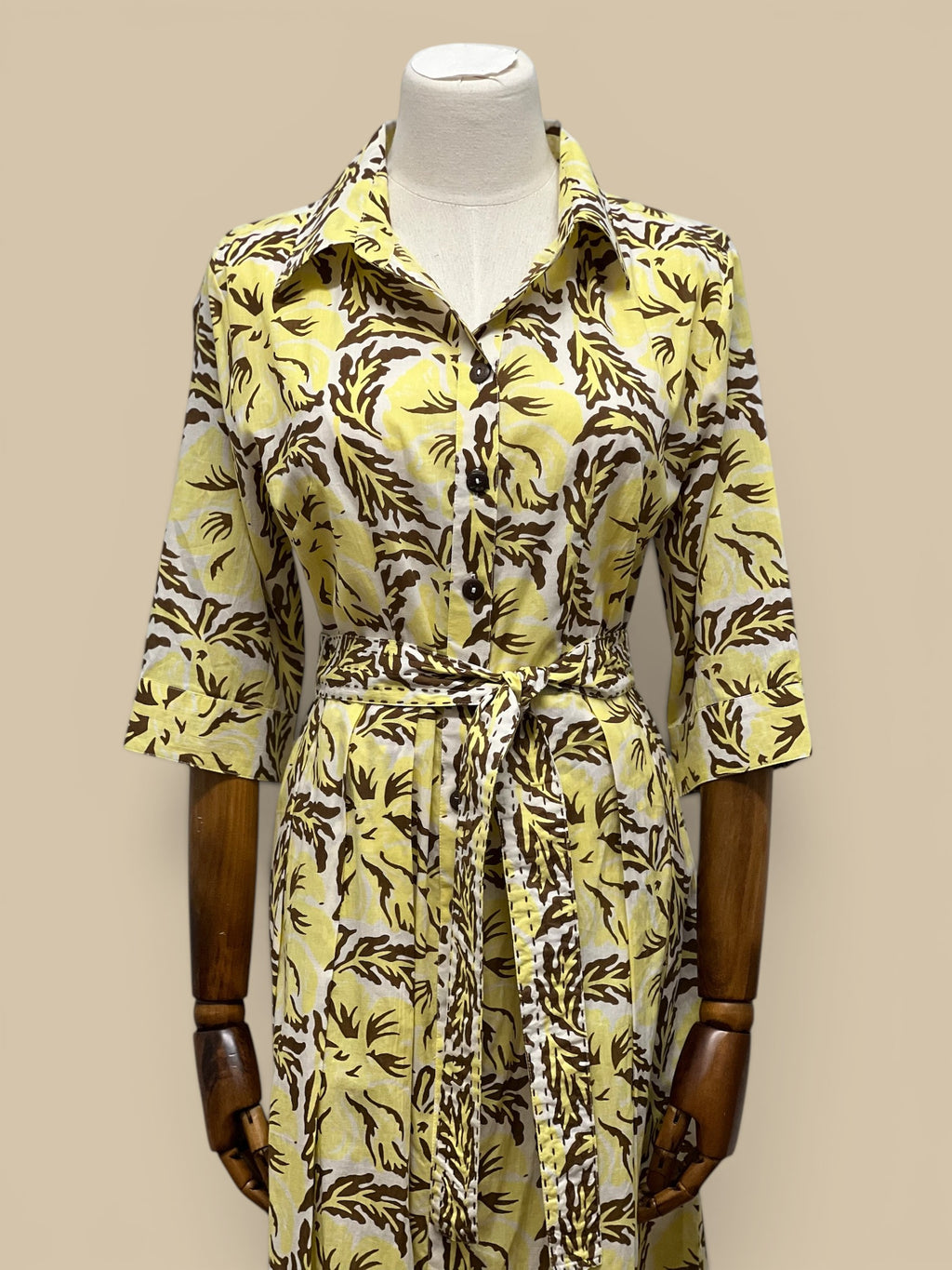 Homestyle Collective yellow cotton block print midi dress with brown floral pattern, tie waist, and coconut buttons.