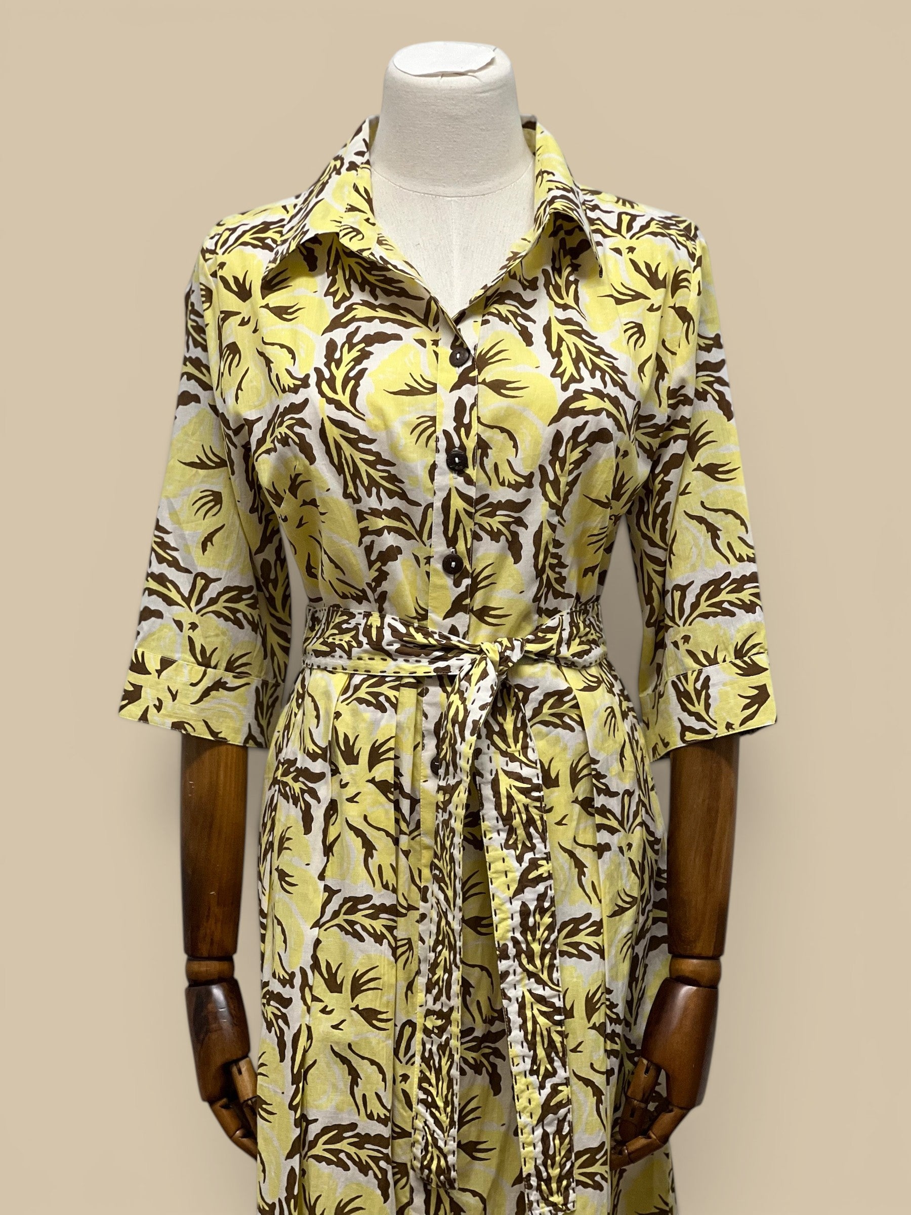 Homestyle Collective yellow cotton block print midi dress with brown floral pattern, tie waist, and coconut buttons.