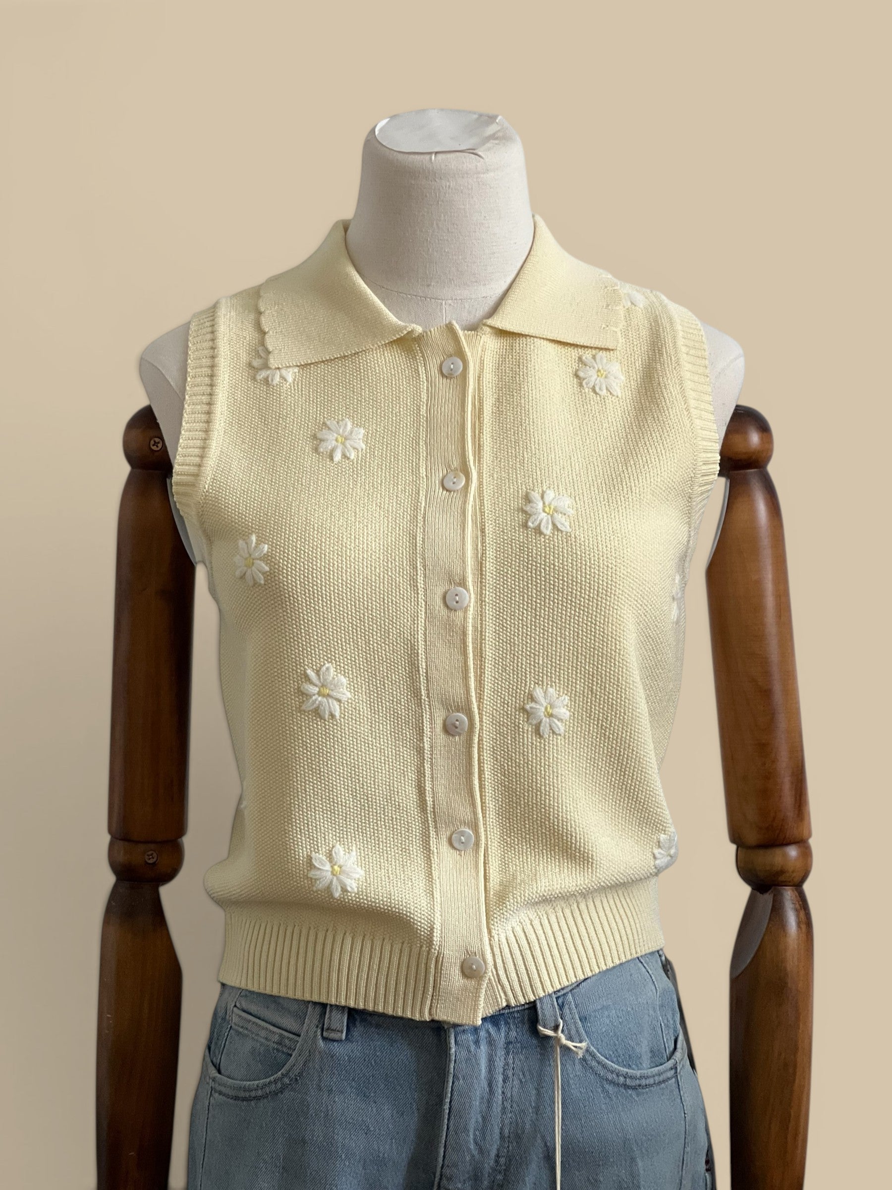 Homestyle Collective butter yellow knit sleeveless collared top with white floral embroidery and button front.